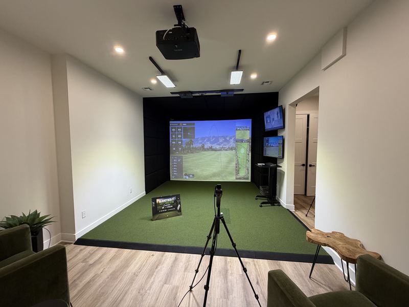 Example build style: custom golf simulator room showing integrated AV: projection, padded acoustic walls, lighting, and audio designed as one system